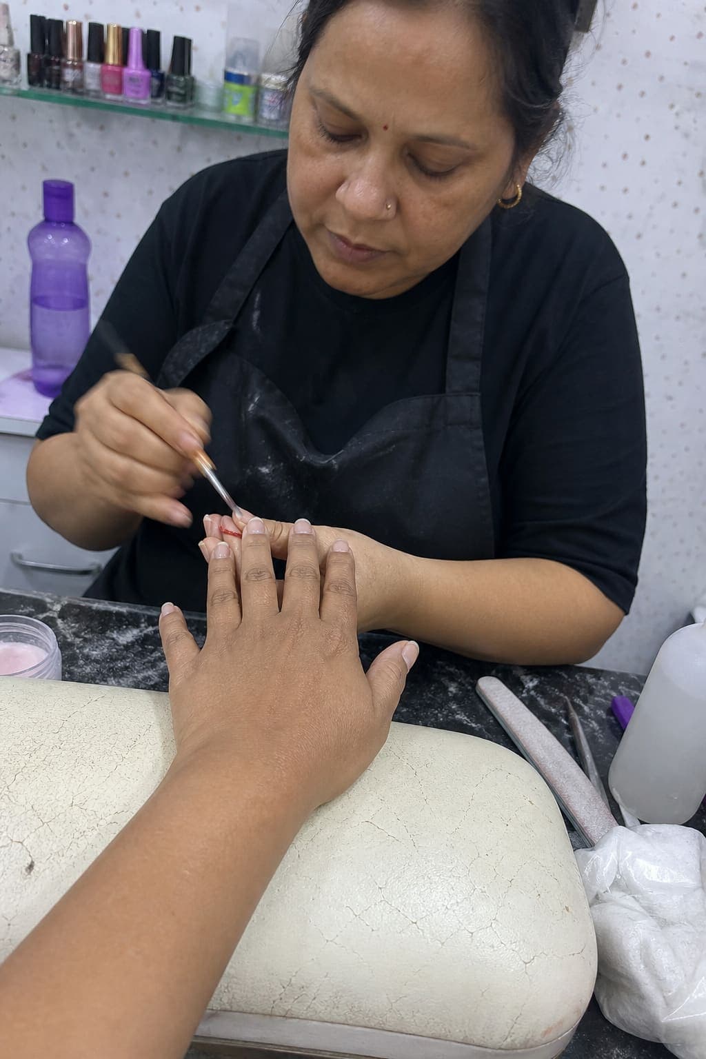 Acrylic nail service in progress